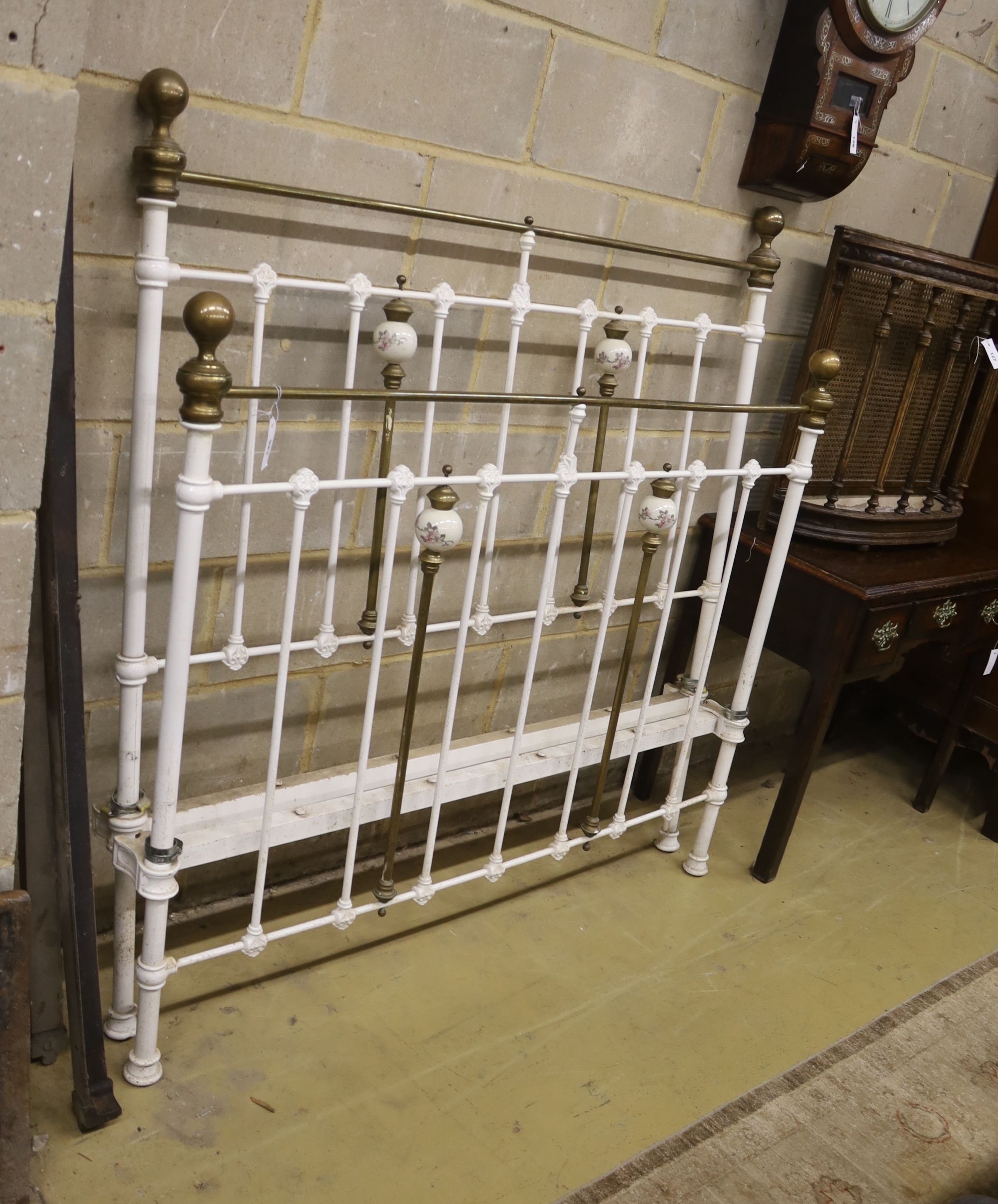 A Victorian style porcelain mounted iron and brass double bed frame, width 136cm